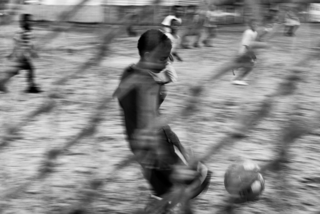 Children playing football on a community field, Mitchell’s Plain, 2011.