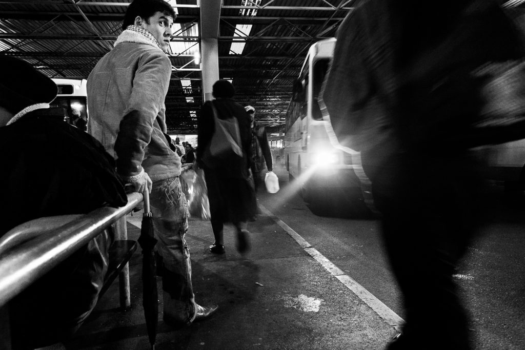 A commuter is waiting on the bus, Cape Town, 2010.