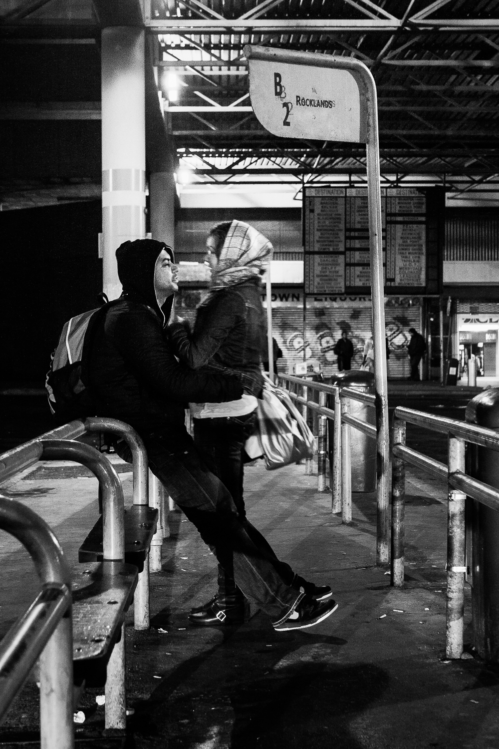 A young couple waiting for the bus to Rocklands, Cape Town, 2009.