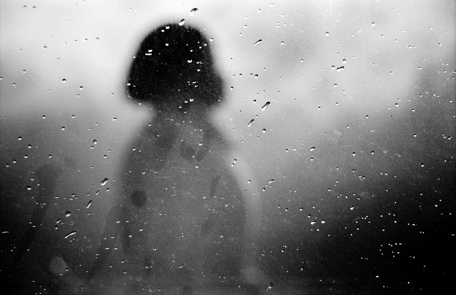 Domestic worker walking past window in Capricorn Park, Cape Town, 2009.