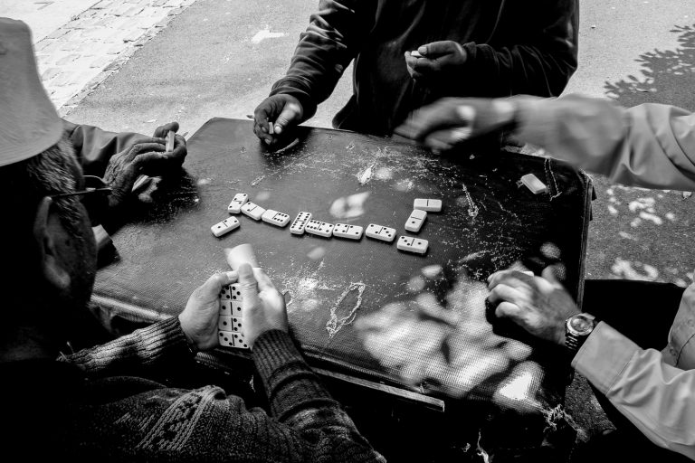 Men playing a game of Dominos in the street, Woodstock 2014.